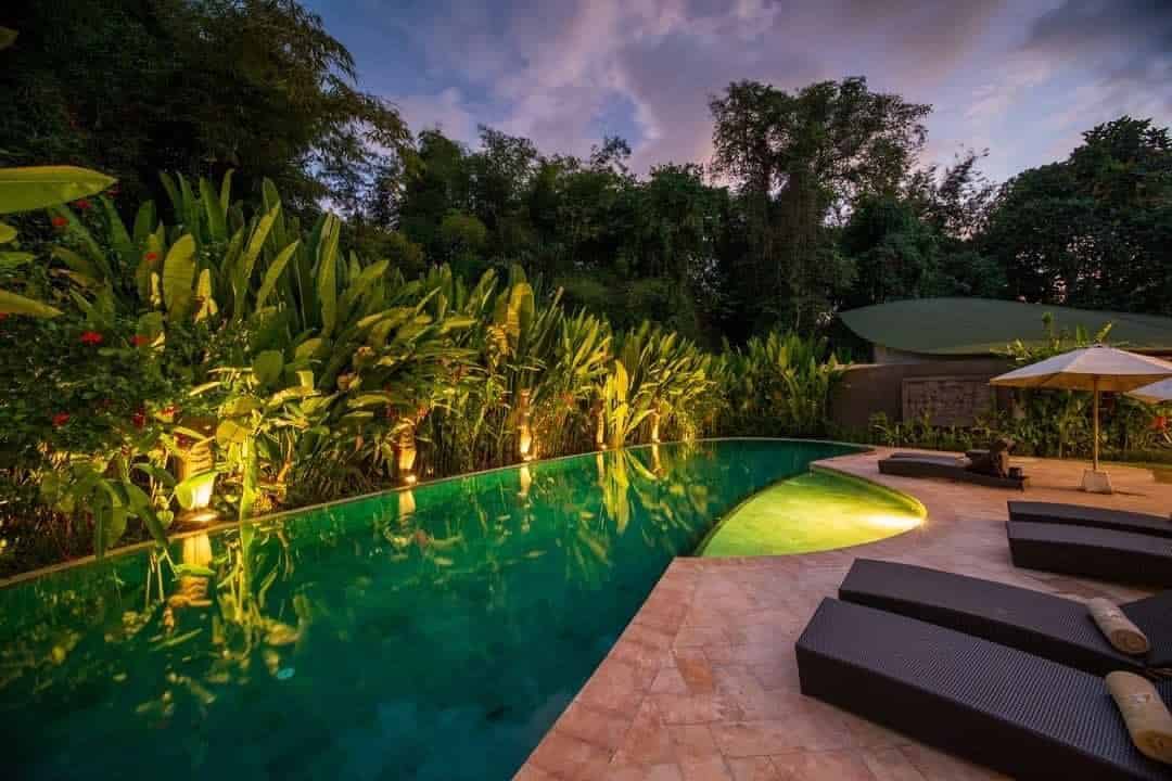 Night swimming at the pool of the De Moksha Eco Friendly Boutique Resort in Tanah Lot in Bali, Indonesia.