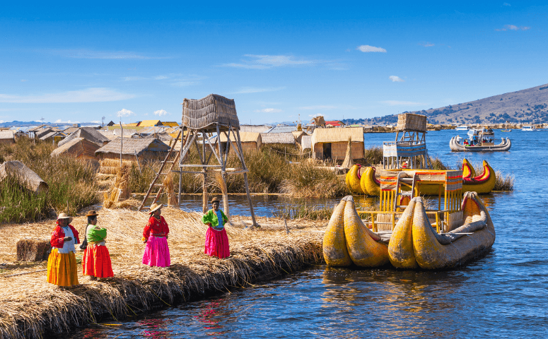 Women and traditional boat at Lake Titicaca in Peru.